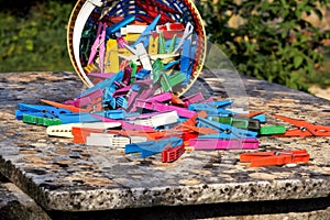 Clothespin in the basket stand on table in garden