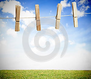 Clothespin on a laundry line outside with bright blue sky