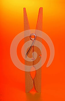 Clothespin,a needle in orange clothes yellow backgroun