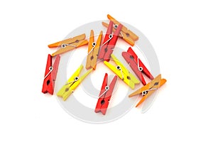 clothespins for clothes. red, yellow and orange on white background