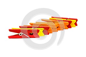 clothespins for clothes. red, yellow and orange on white background