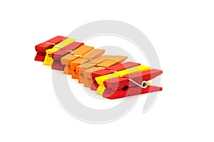 clothespins for clothes. red, yellow and orange on white background