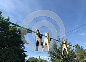 Clothespins on a clothesline against a bright blue sky