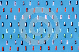 Clothespins colored on a blue background.