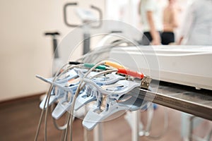 Clothespins of the ECG machine in the foreground. Athlete does a cardiac stress test and VO2 in a medical study