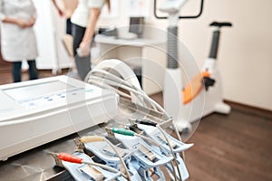 Clothespins of the ECG machine in the foreground. Athlete does a cardiac stress test and VO2 in a medical study