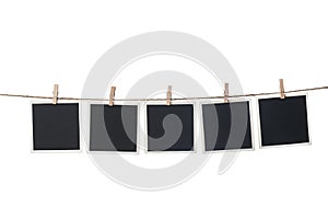 Clothespins with empty instant frames on string against white background. Space for text