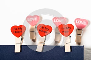 Clothespins with hearts on a blue envelope. Love letter concept. Valentine`s day concept. Declaration of love