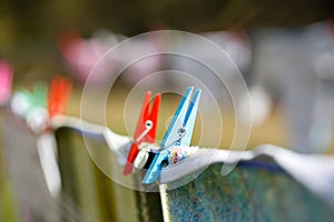 Clothespins holding laundry on the drying line