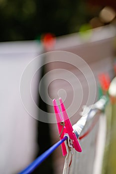 Clothespins holding laundry on the drying line