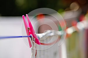 Clothespins holding laundry on the drying line