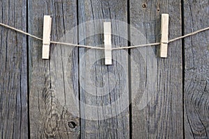 Clothespins on rope and empty vintage wooden planks