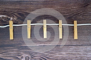 Clothespins on rope and empty vintage wooden planks background. Close up macro