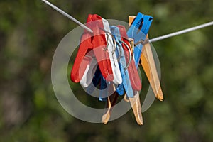 Clothespins on ropes in yard of house.