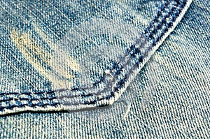 clothing items blue stonewashed faded jeans cotton fabric texture with seams, clasps, buttons and rivets, macro, close-up