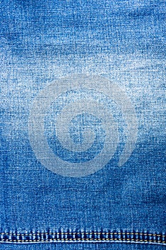 clothing items blue stonewashed faded jeans cotton fabric texture with seams, clasps, buttons and rivets, macro, close-up