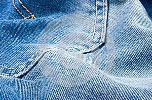 clothing items blue stonewashed faded jeans cotton fabric texture with seams, clasps, buttons and rivets, macro, close-up