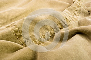 clothing items stonewashed cotton fabric texture with seams, clasps, buttons and rivets, macro