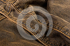 clothing items stonewashed cotton fabric texture with seams, clasps, buttons and rivets, macro