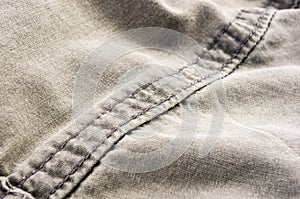 clothing items stonewashed cotton fabric texture with seams, clasps, buttons and rivets, macro