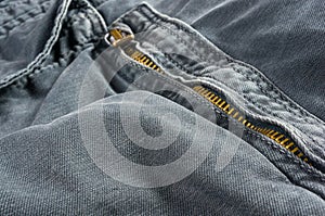 clothing items stonewashed cotton fabric texture with seams, clasps, buttons and rivets, macro