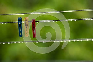 clothing lines of a clothes spin with many raindrops at the string in front of a dark background, after the rain. Retro way of