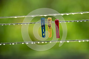 clothing lines of a clothes spin with many raindrops at the string in front of a dark background, after the rain. Retro way of