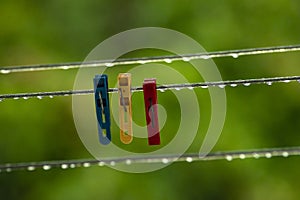 clothing lines of a clothes spin with many raindrops at the string in front of a dark background, after the rain. Retro way of