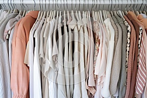 On clothing rack hangers, stylish clothes hang in closet