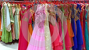 Clothing racks with colored wedding dresses