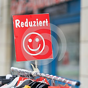 Clothing reduced in price in front of a store in Magdeburg in Germany