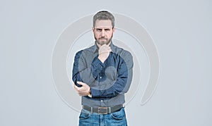 Clothing for the serious man. Bearded man think grey background. Serious look. Chin propping