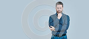 Clothing for the serious man. Bearded man think grey background. Serious look. Chin propping. Man face portrait, banner