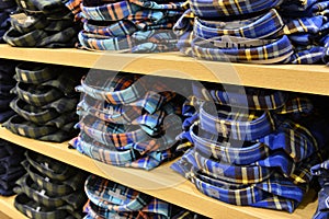 Clothing stacked neatly on the shelf in fashion shop