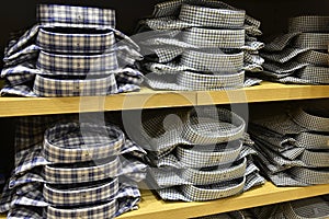 Clothing stacked neatly on the shelf in fashion shop photo
