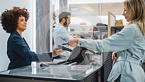 Clothing Store Checkout Cashier Counter: Woman and Male Retail Sales Managers Accept NFC Smartphone