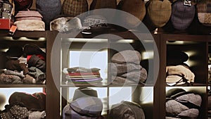 Clothing store showcase with variety of mens flat caps, womens hats and berets