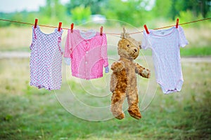 Clothing and a teddybear on a clothesline