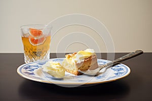 clotted cream beside a split scone