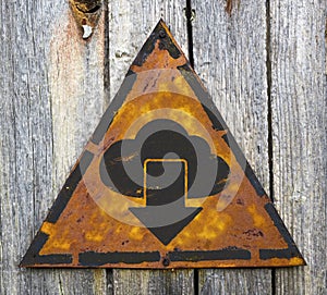 Cloud with Arrow Icon on Rusty Warning Sign.