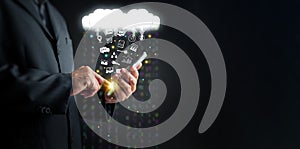 Cloud Computing Concept. A man uses a smartphone to upload and download IT resources via cloud technology