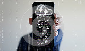Cloud Computing Concept.A man uses a smartphone to upload and download IT resources via cloud technology