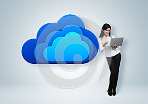 Cloud computing idea concept. Businesswoman stands by the cloud