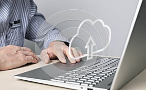 Cloud computing. Man using laptop for files upload, storage or sharing online. Male hand on computer touchpad closeup