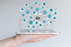 Cloud computing and mobile computing concept. Male hand holding modern smart phone