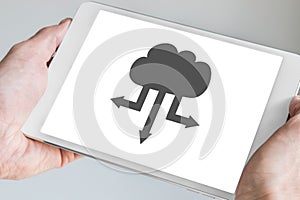 Cloud computing symbol for upload and download displayed on touch screen of modern tablet