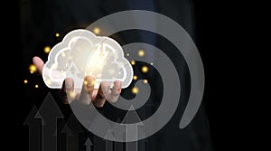 Cloud computing technology, upload and download server concept. Businessman holding cloud icon with datum shining light on black