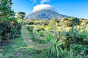 Cloud covered volcano, meadow & orchard, Guatemala photo