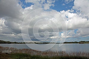 A cloud filled sky over a lake in Everglades National Park, FL.