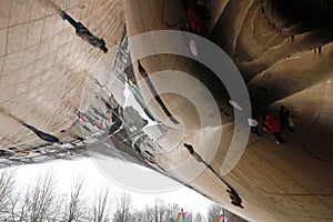 Cloud gate at Chicago Illinois Bean mirror art with people and buildings mirrored tourist landmark at this mayor USA city.